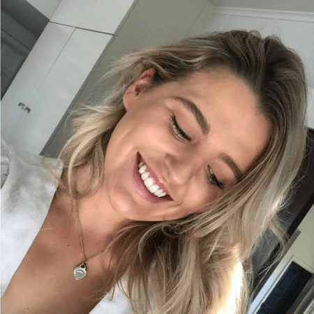 Happy client showing white smile after laser teeth whitening Christchurch
